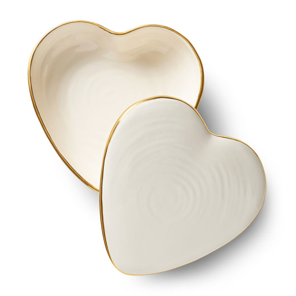 The Aerin Cream Calinda Heart Box features two overlapping heart-shaped ceramic plates with gold detailing on a pristine white background.