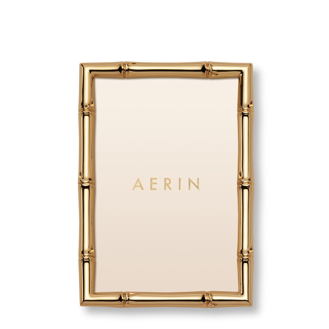 The Ava Bamboo Frame Collection by Aerin features a rectangular gold-finish frame with a bamboo-style design and a blank insert displaying "AERIN" at the center.