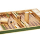 The Aerin Croc Leather Backgammon Set showcases green and white points, wooden checkers, dice, a doubling cube, and dice cups—all presented on a luxurious Italian crocodile leather surface.