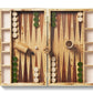 The Aerin Croc Leather Backgammon Set features an open board with checkers, dice, a 32 doubling cube, and two dice cups on a wooden surface, all in a luxurious Italian leather crocodile finish.