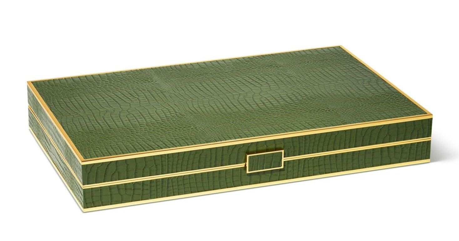 AERIN’s Croc Leather Backgammon Set comes in a rectangular green crocodile-finish box with gold trim and a centered gold latch, offering an elegant way to store your Italian leather game set.