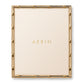 Aerin's Ava Bamboo Frame Collection features a gold-finished, bamboo-style rectangular photo frame with a cream background and the brand name "AERIN" in gold letters at the center.