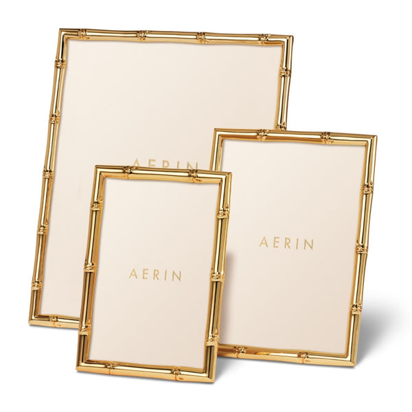 Three AERIN Ava Bamboo Frames with luxurious gold finishes stand upright against a white background.