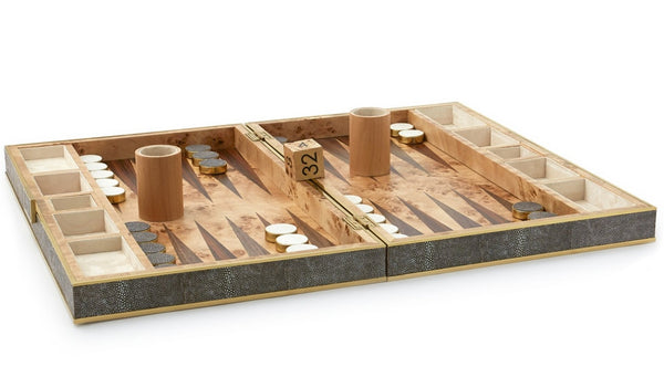 An **AERIN Shagreen Backgammon Set, Chocolate**, adorned with a shagreen finish, displays playing pieces and dice, with two dice cups and a doubling cube in the center.