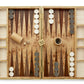 The Aerin Shagreen Backgammon Set in Chocolate features a luxurious shagreen finish, black and white checkers ready for play, dice, a 32 doubling cube, and a dice cup—ideal for classic board game enthusiasts.