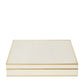 The Aerin Shagreen Chess Set Collection features a closed, rectangular cream-colored shagreen box with gold trim, displayed against a white background.