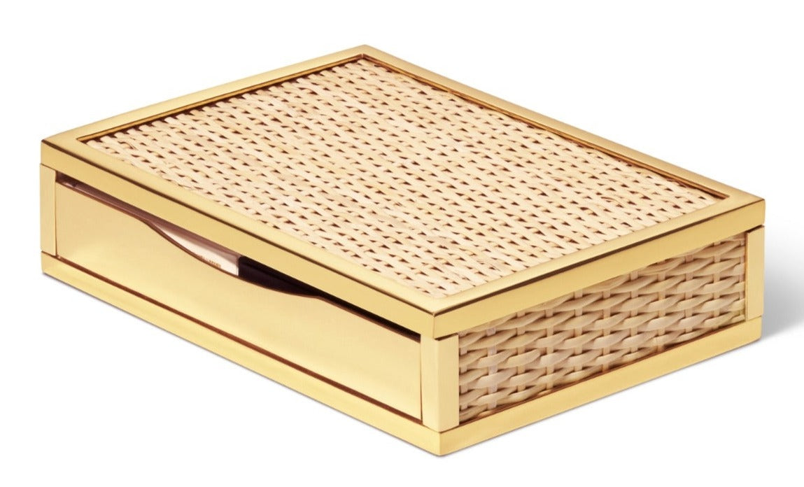 The Colette Cane Card Set by Aerin features a rectangular box with gold metallic edges, woven cane drawer panels, and a side handle, all set against a white background.