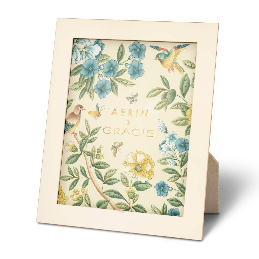 Introducing the AERIN x Gracie Heathcote Frame from Aerin, a decorative picture frame adorned with an exquisite floral and bird design, featuring the names "Aerin" and "Gracie" at the center – perfect for complementing traditional interiors.
