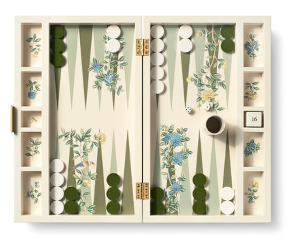 The AERIN x Gracie Heathcote Lacquer Backgammon Set by Aerin features a Heathcote design with green and white checkers, dice, a doubling cube on 16, and a cup, all set against a hand-painted wallpaper backdrop.