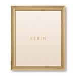 The Alessio Frame Collection by Aerin features a gold reeded rectangular design, with "AERIN" in gold on a cream background—ideal for elegantly displaying your favorite photos.