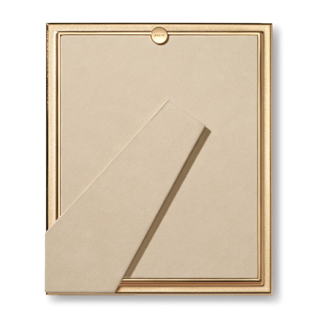 The Alessio Frame Collection by Aerin features a gold-edged rectangular frame with a reeded design, beige back, and angled support stand for elegant photo display on any tabletop.