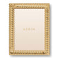 The Loretta Frame Collection by AERIN features a gold twist design with the brand name centered on a light background, offering an elegant way to display your photos.