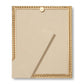 The Loretta Frame Collection by Aerin features a gold frame with beige backing and stand, showcasing a subtle twist design, viewed from the back against a plain white background.