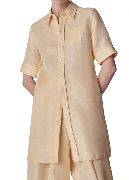 A person wearing a CO Short Sleeve Shirt Dress with MOP buttons.