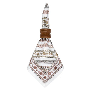A Seville Stripe Napkin from Juliska—crafted from white cotton sateen with brown and beige floral patterns inspired by hand-painted Spanish tiles—is folded through a dark wood napkin ring, set against a plain white background.