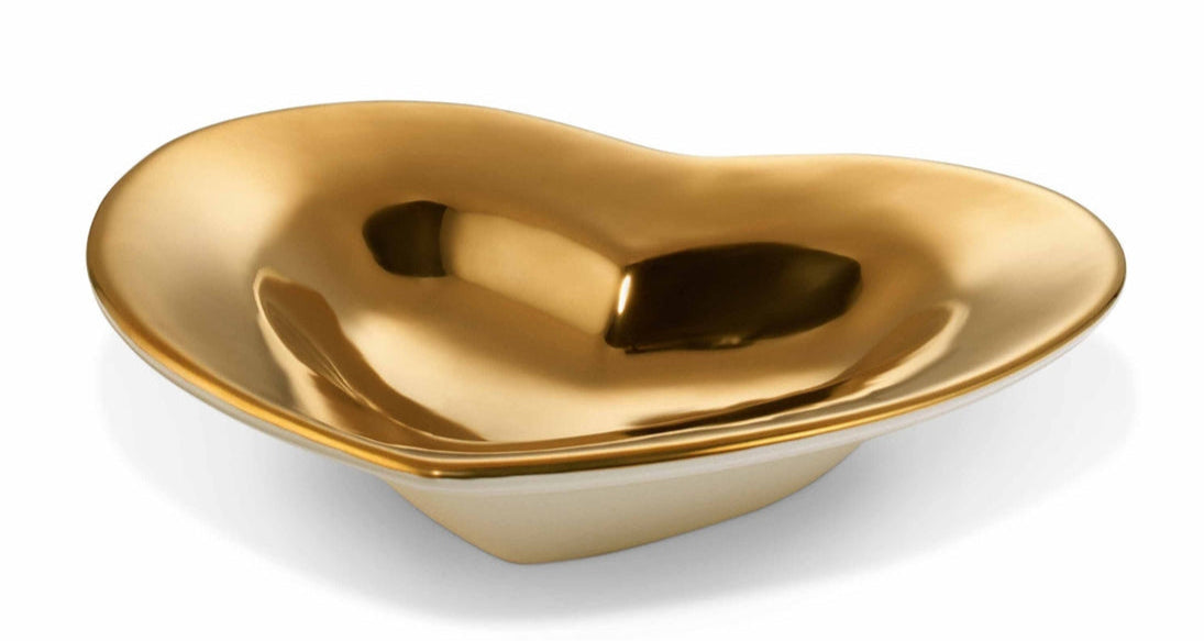 The Aerin Gilded Heart Dish features a shiny, irregular shape and smooth surface, crafted in Italy with a luxurious 24k gold finish and shallow depth, shown against a white background.