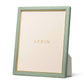 The Piero Leather Frame Collection by Aerin is a green Italian leather photo frame with gold detailing and a placeholder insert featuring the Aerin logo for an elegant display.