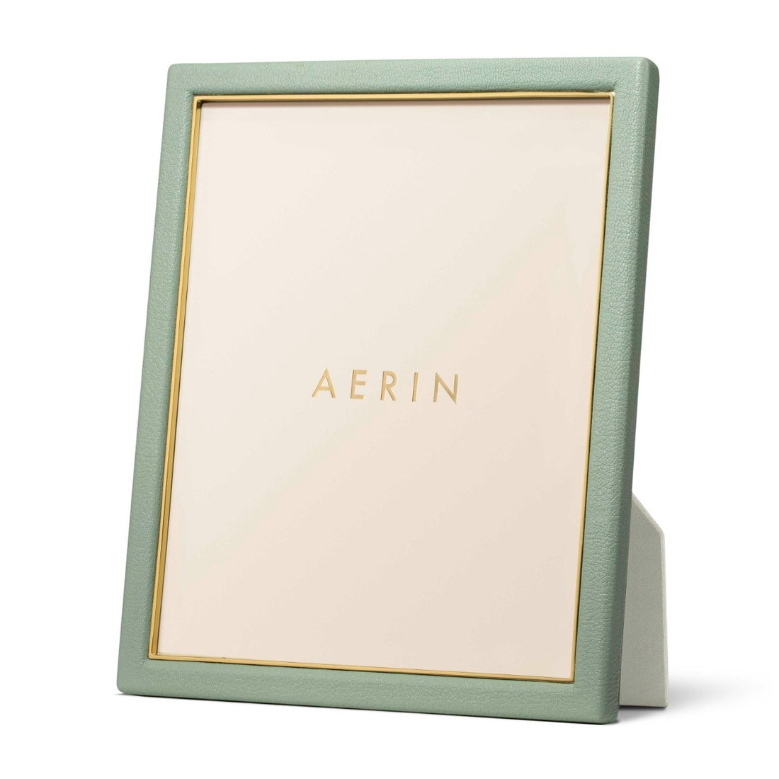 The Piero Leather Frame Collection by Aerin is a green Italian leather photo frame with gold detailing and a placeholder insert featuring the Aerin logo for an elegant display.