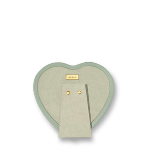 The Eucalyptus Piero Leather Heart Frame by Aerin features Italian sage green leather, gold accents, a stand, and a gold nameplate labeled "AERIN," shown from the back against a plain white background.