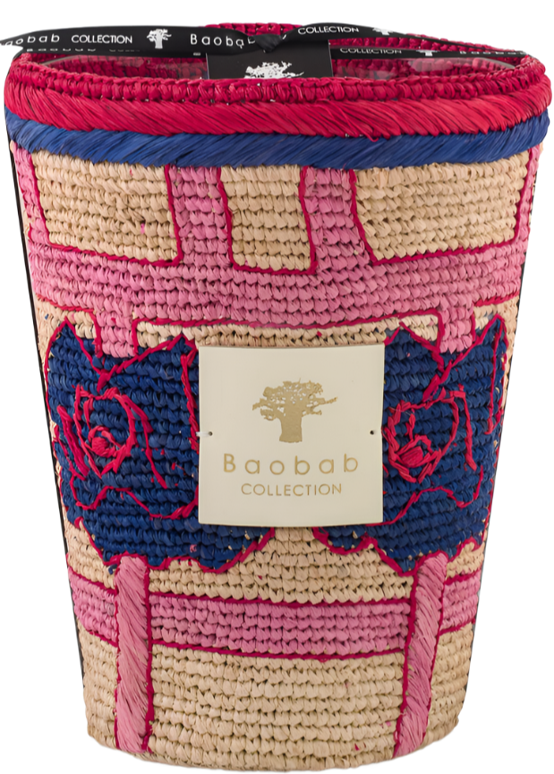 A decorative Baobab collection basket with a pink and navy blue braided design and textured patterns, featuring a gold label with a Baobab Frida Draozy candle emblem.