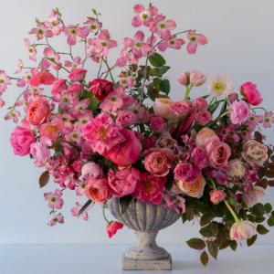 A floral arrangement inspired by Kiana Underwood’s signature style from Chronicle Books’ “Color Me Floral” is displayed in a stone vase, set against a simple light background.