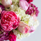 A close-up of the Hive Floral Studio Live Mother's Day Floral Arrangement, featuring vibrant pink roses, peonies, and white hydrangeas—a stunning mix of pink and cream blossoms perfect for celebrating Mom.