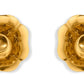 Two gold-toned Olivia Brass Taper Candleholders by Aerin, featuring a vintage flower-shaped design, are displayed side by side on a white background.