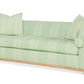 Highland House Barrow Sofa in light green with Green Greco Stripe upholstery features two square pillows, two cylindrical bolsters, a subtle geometric pattern, and a wooden base.