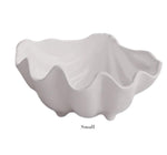 The Vida Ocean Shell Bowl Collection by Beatriz Ball features a stylish white bowl with a wavy, clam shell-inspired edge. Made from luxury melamine, it is dishwasher safe. The word "Small" appears below the bowl.