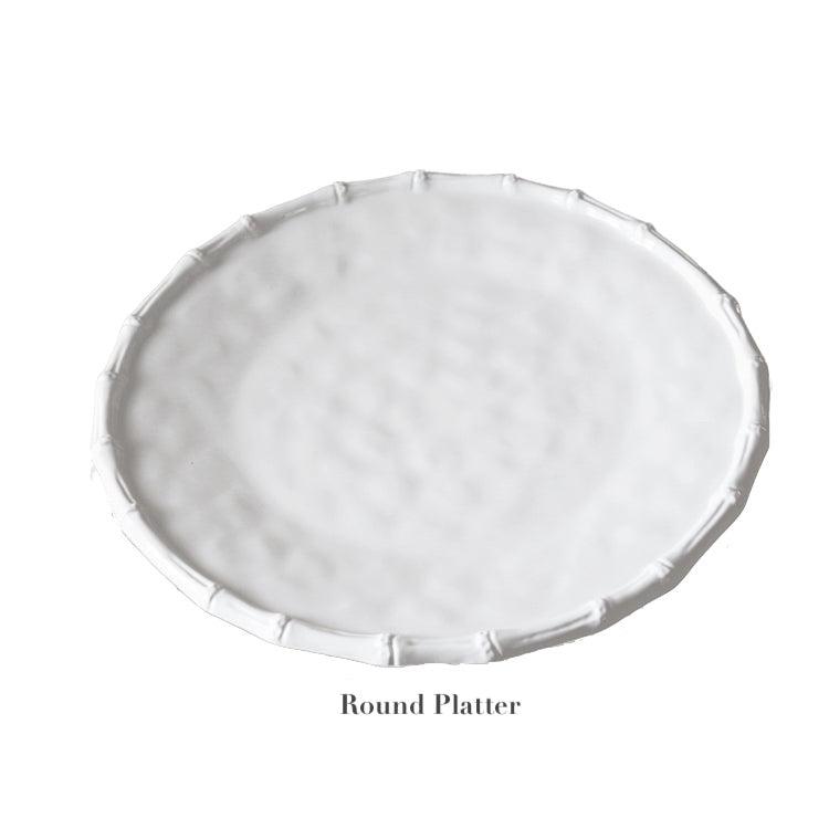 From the Vida White Bamboo Serveware Collection by Beatriz Ball, this white ceramic round platter features a textured surface and raised decorative edge—ideal for elegant presentations on any occasion. Shown on a plain background.