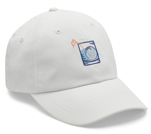 White Peter Millar Golf On The Rocks Performance Hat made from lightweight performance fabric, with a blue embroidered patch featuring a mountain and water design, displayed on a white background.