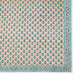 The Alwar Table Linen Collection by SLOANE BY HAND features a cream rectangular fabric with blue florals and an ornate blue border—perfect as hand block printed tablecloth or napkin set for elegant dining.