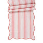 The Juliska Cabana Stripe Tabletop Collection features folded red and white striped fabric with breezy, wavy edges.