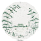 The Juliska Country Estate Winter Frolic Evergreen Dinnerware Collection features a white charger plate with scalloped edges, adorned with a green winter landscape—ideal for festive country estate gatherings.