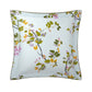 Square pillow from the Yves Delorme Luciole Bedding Collection, made of organic cotton sateen with a white background, botanical print in green, yellow, and pink, and finished with slender green piping.
