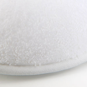 Close-up view of the edge of Etoile Blanc Slippers by Yves Delorme, featuring ultra-absorbent, white long-staple cotton fabric on a white background.