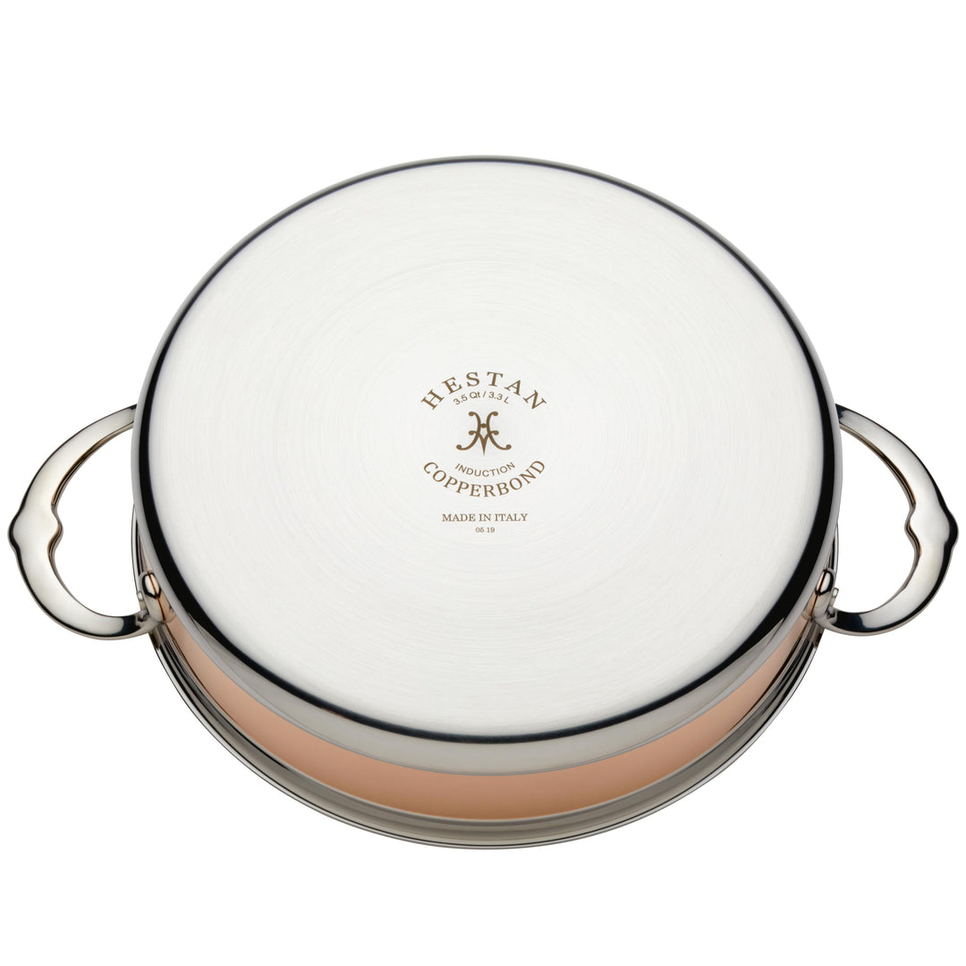The Hestan CopperBond Copper Induction Sauteuse, 3.5qt, features two handles and engraved "Hestan CopperBond Made in Italy" branding on its bottom. Induction compatible and designed for copper innovation.