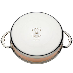 The Hestan CopperBond Copper Induction Sauteuse, 3.5qt, features two handles and engraved "Hestan CopperBond Made in Italy" branding on its bottom. Induction compatible and designed for copper innovation.