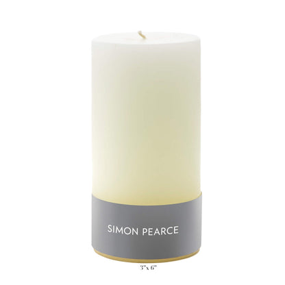 An ivory pillar candle from the Simon Pearce Ivory Candle Collection stands upright on a plain white background—an artisan creation crafted in small batches to enhance any home.