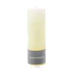 The Ivory Candle Collection by Simon Pearce features a tall, white pillar candle (2" x 6") with elegant artisan craftsmanship—perfect for adding warmth and sophistication to your home.