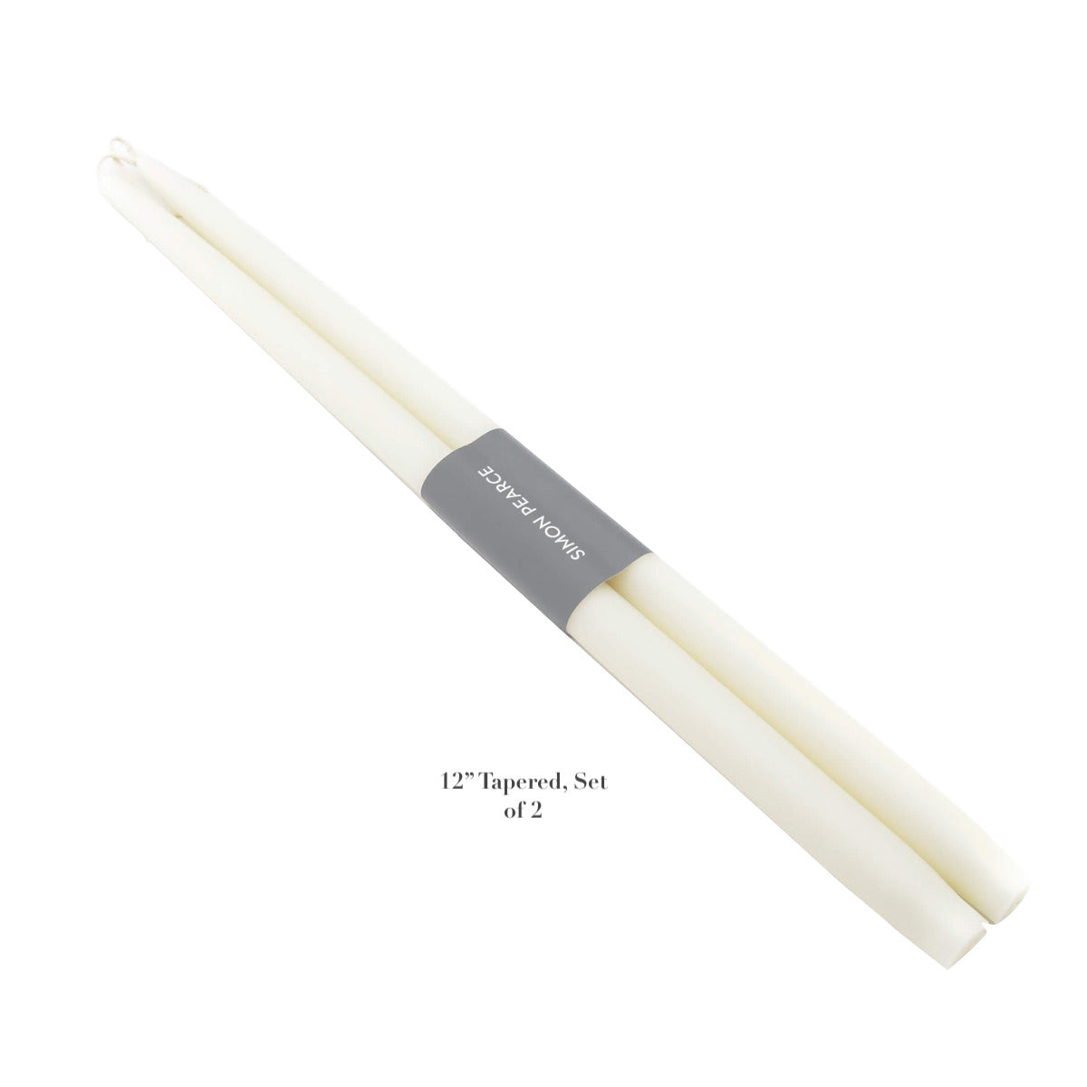 The Ivory Candle Collection by Simon Pearce features two 12-inch white artisan candles, wrapped with a gray band displaying the brand—an elegant addition to any home.