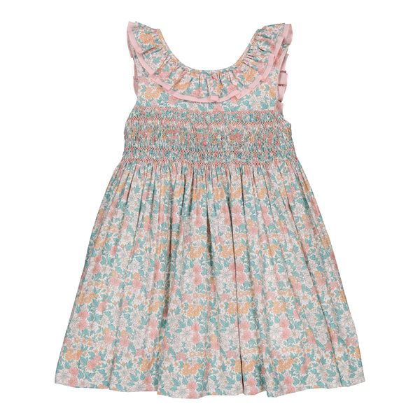 A Kidiwi Melina Smocked Dress, a floral patterned, lightweight, sleeveless summer dress with ruffled neckline on a white background.