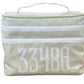 The Walton Travel Case by Walker Valentine is a rectangular packing organizer, green and white striped, with double zipper compartments and the number 33480 in bold white letters on the front.