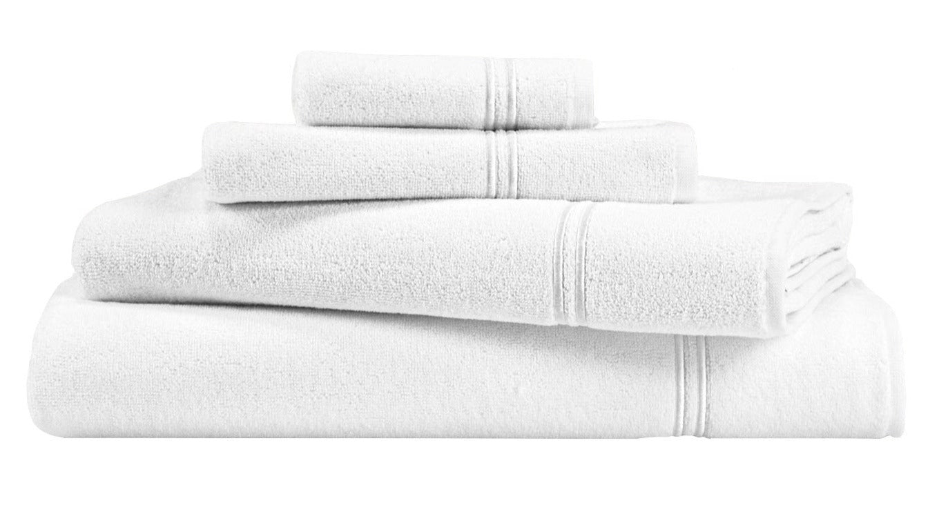 The Frette Classic White/White Bath Collection features neatly stacked cotton terry towels in various sizes, set against a white background—ideal for a stylish bathroom.