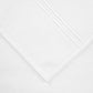Close-up of a neatly folded towel from the Frette Classic White/White Bath Collection, crafted from soft cotton terry with decorative lines—an elegant accent for a stylish bathroom.