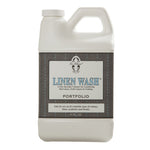 A plastic bottle of Le Blanc Linen Wash, a specialty cleanser designed for laundering luxury bed linens, table linens, and clothing with an effective cold water formula.