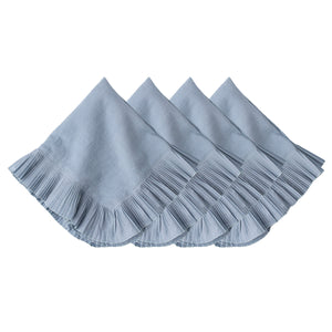 The Juliska Mademoiselle Napkin Set features four light blue napkins with knife-pleat ruffle borders, neatly stacked against a white background—ideal for adding romance to any tablescape.