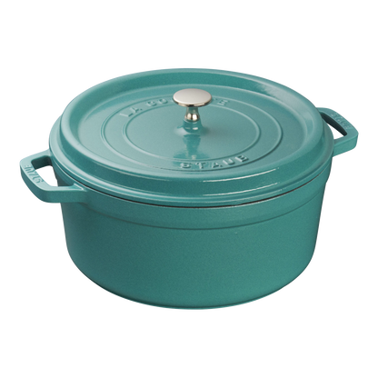 The Staub Cast Iron Dutch Oven Collection features a teal enameled Dutch oven with a lid, side handles, and a silver knob—perfect for slow-cooking.