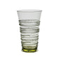 Handcrafted from clear mouth-blown glass with a subtle green tint, the Ella Drinkware Collection tumbler by Juliska features raised spiral and dot motifs swirling around the exterior—an exquisite example of artisan craftsmanship.