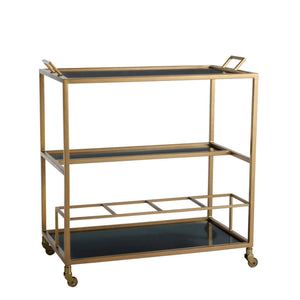 Arteriors Jak Bar Cart in antique brass featuring three tiers, two handles, removable black glass trays, and casters.